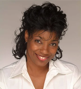 Headshot of the founder in a white blouse against a neutral background